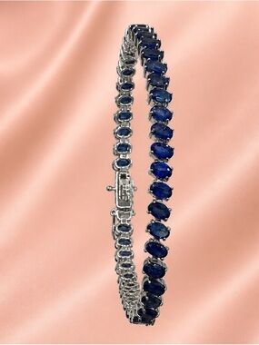 Blue Sapphire Tennis Bracelet set in rhodium over 925 Sterling Silver. 7”. NEW!